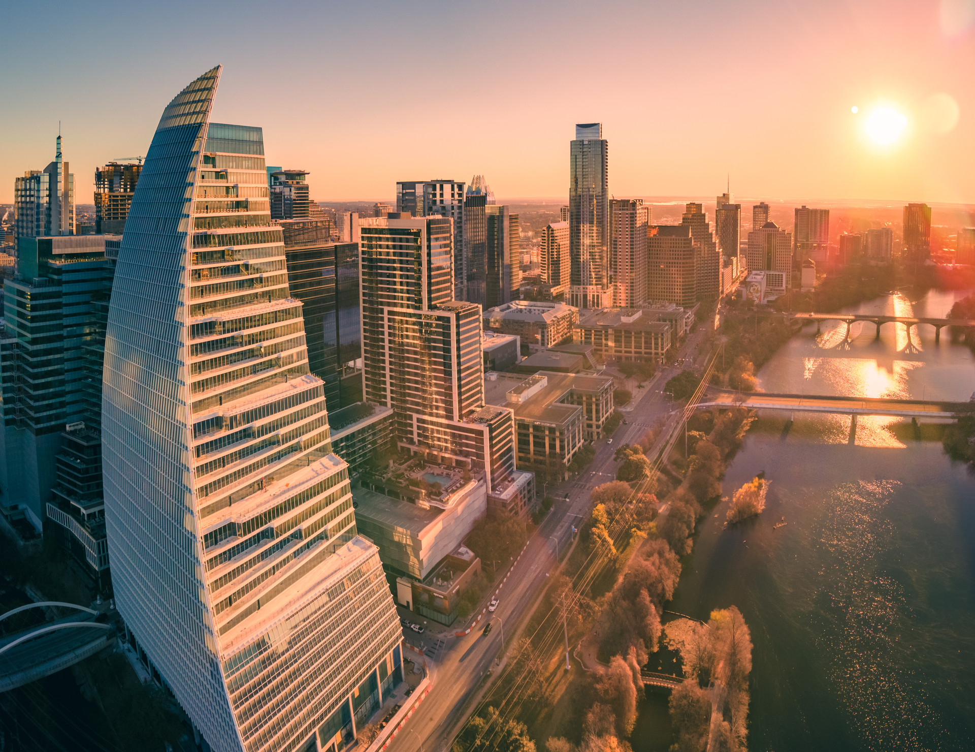 Aerial view of the downtown Austin, Texas skyline at sunset along Lady Bird Lake